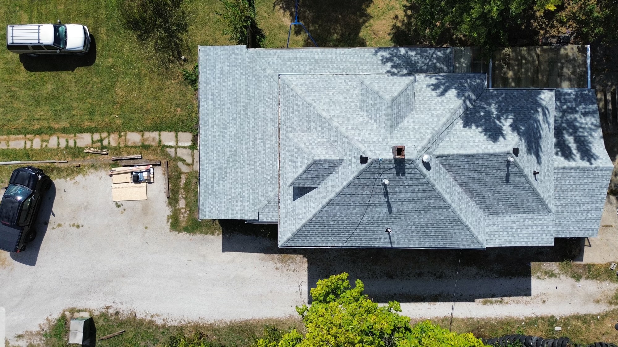 Aerial drone shot of a freshly installed asphalt shingle roof
