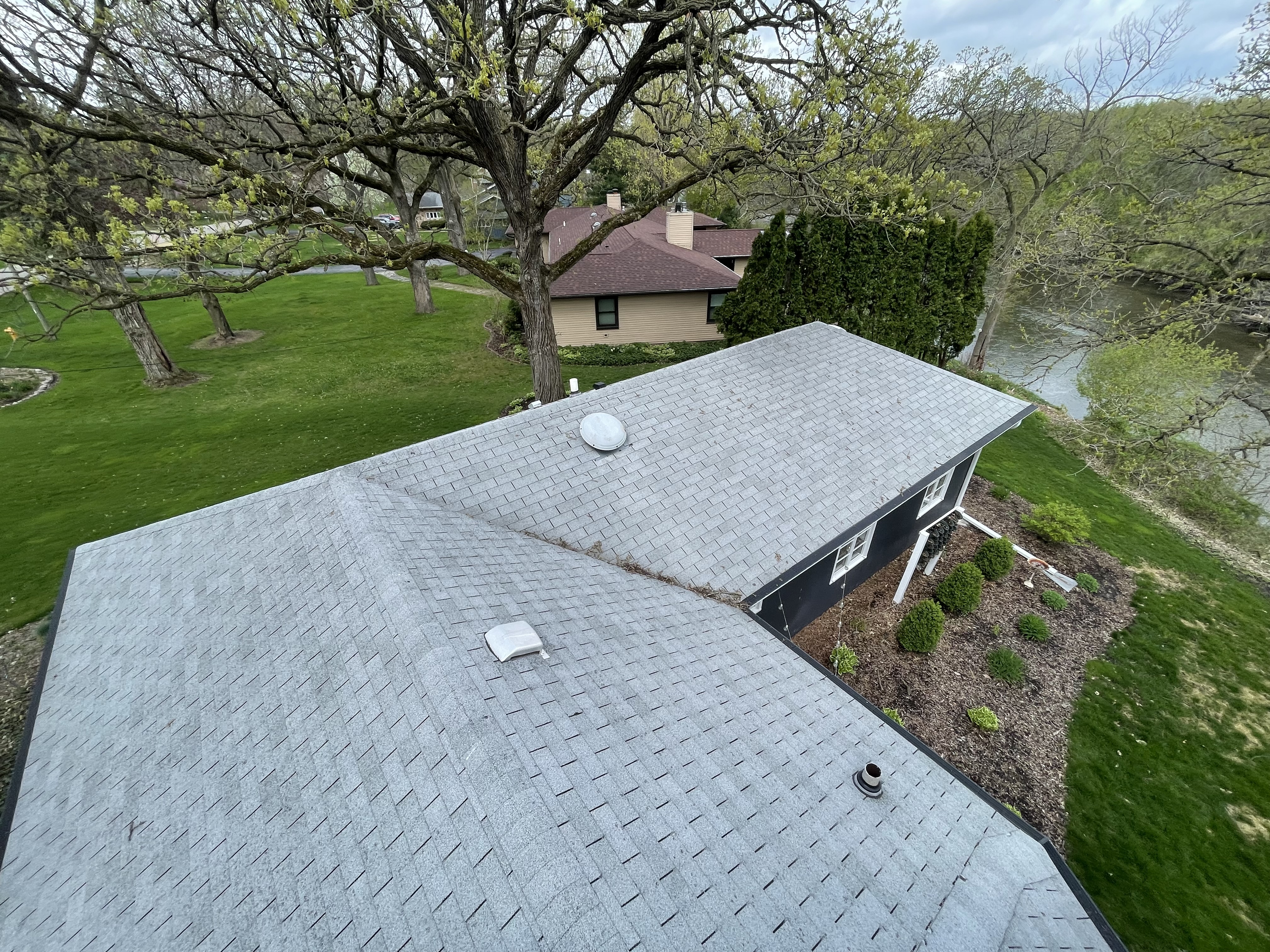 Aerial shot of new asphalt shingle roof installed by Pixler Construction