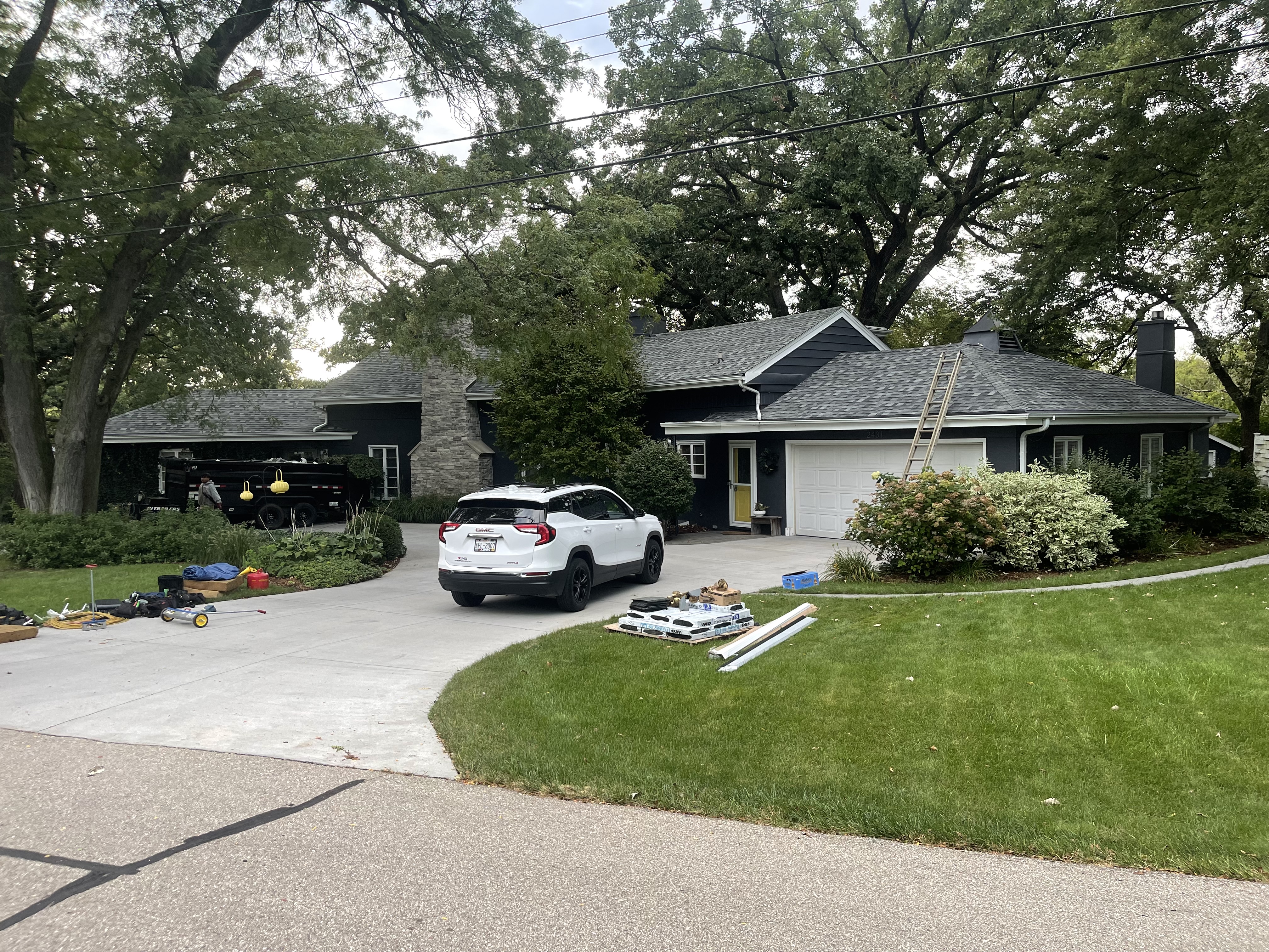 Black ranch home with new dark architectural shingles