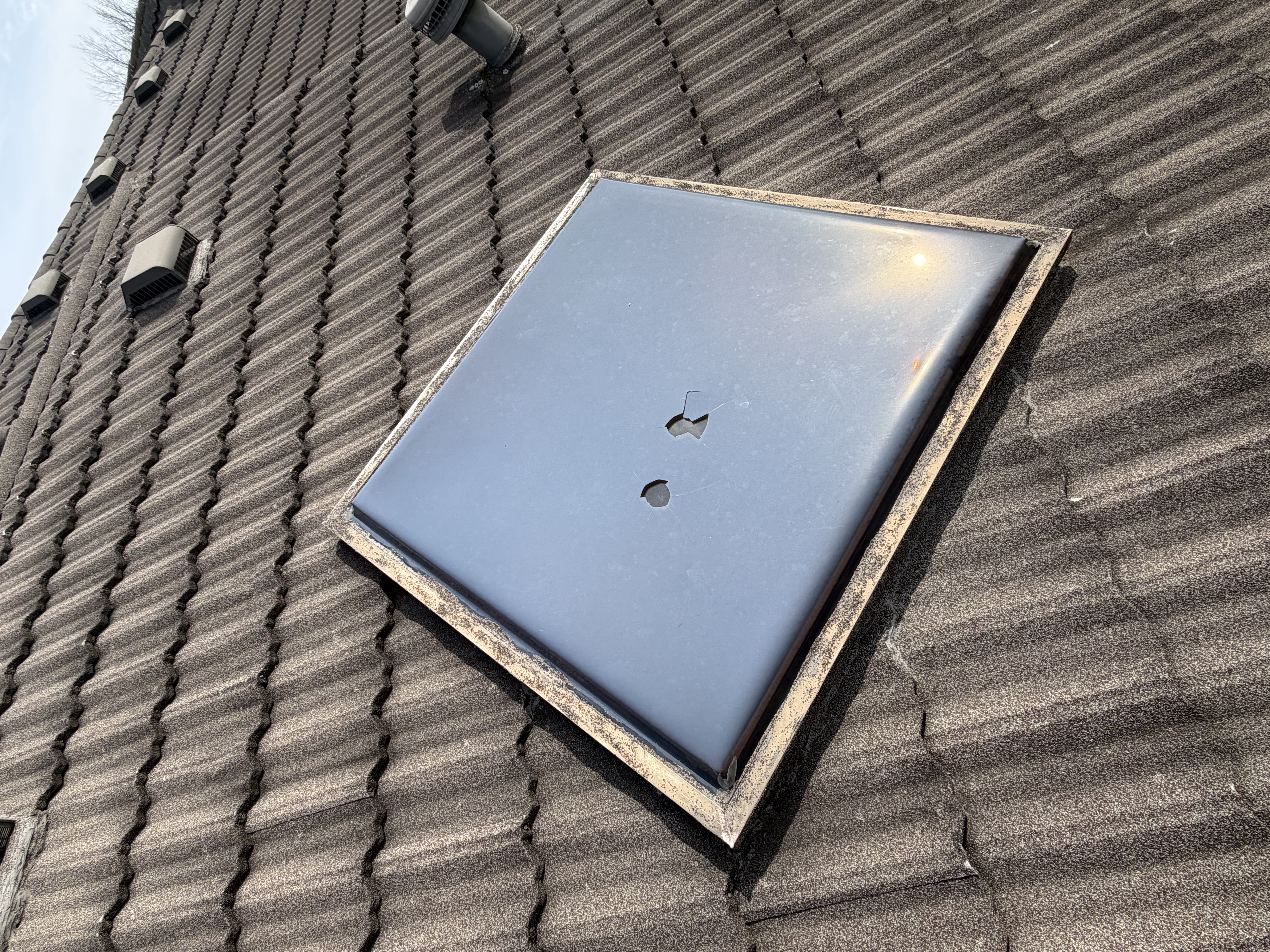 Damaged roof vent flashing documented for an insurance claim