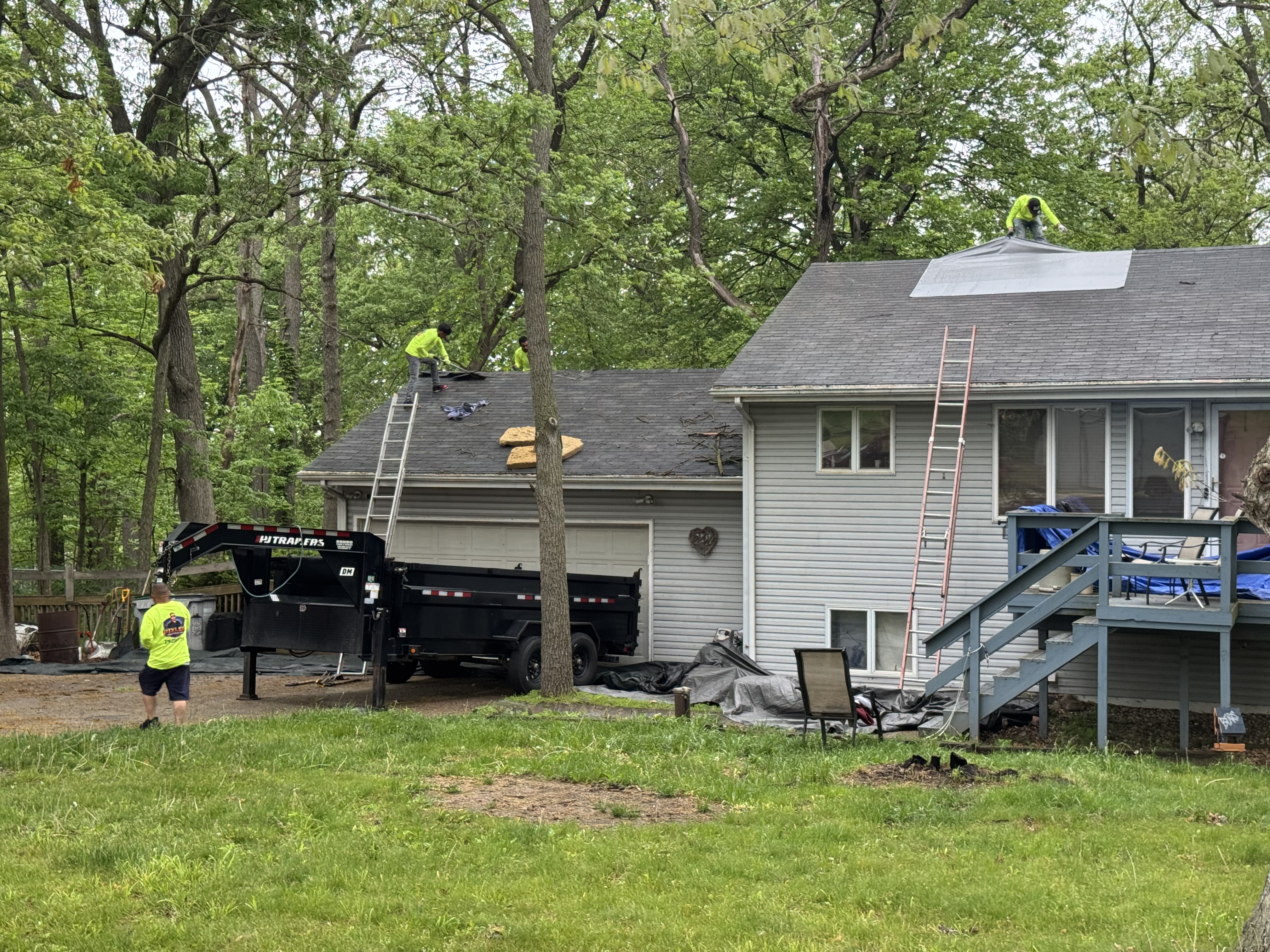 Pixler crew mid roof tear off with dump truck staged in the driveway